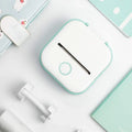Beckett portable printer with compact design, showing a sleek black device and paper output on a plain background.