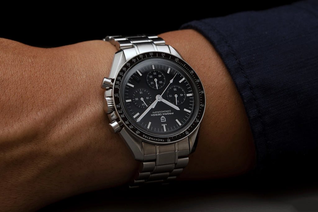 PAGANI DESIGN Moonwatch Chronograph Watch with black dial, stainless steel case, and multiple subdials on a black strap.