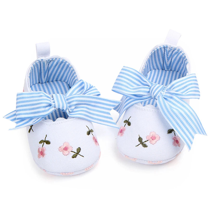 Home Sweet Home baby girl floral embroidered first walker shoes with soft soles, featuring colorful flower designs and delicate embroidery.