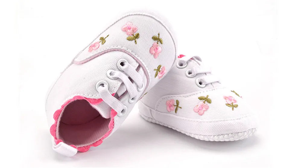 Baby girl floral embroidered soft sole crib shoes by Home Sweet Home, featuring delicate flower details and comfortable first walker design.
