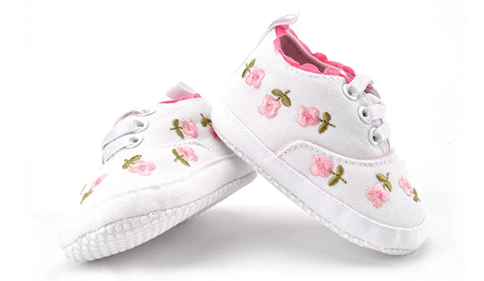 Baby girl floral embroidered first walker shoes by Home Sweet Home with soft soles and colorful flower designs.