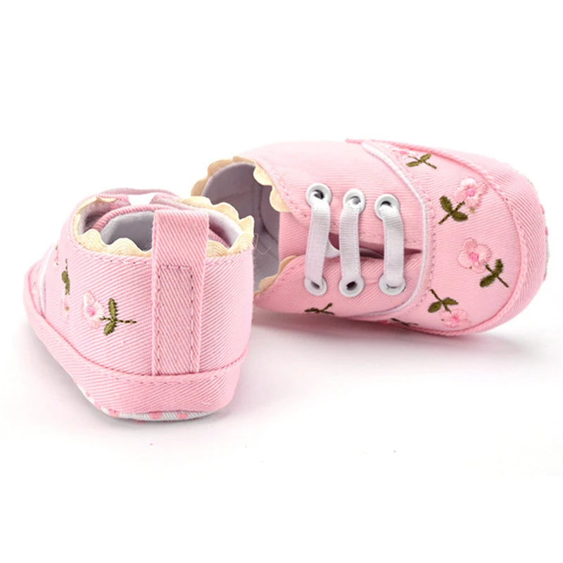 Baby girl floral embroidered soft sole crib shoes by Home Sweet Home, featuring delicate flower patterns and comfortable design.