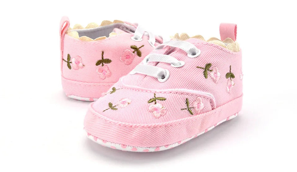 Baby girl floral embroidered first walker shoes by Home Sweet Home with soft soles and delicate flower details.