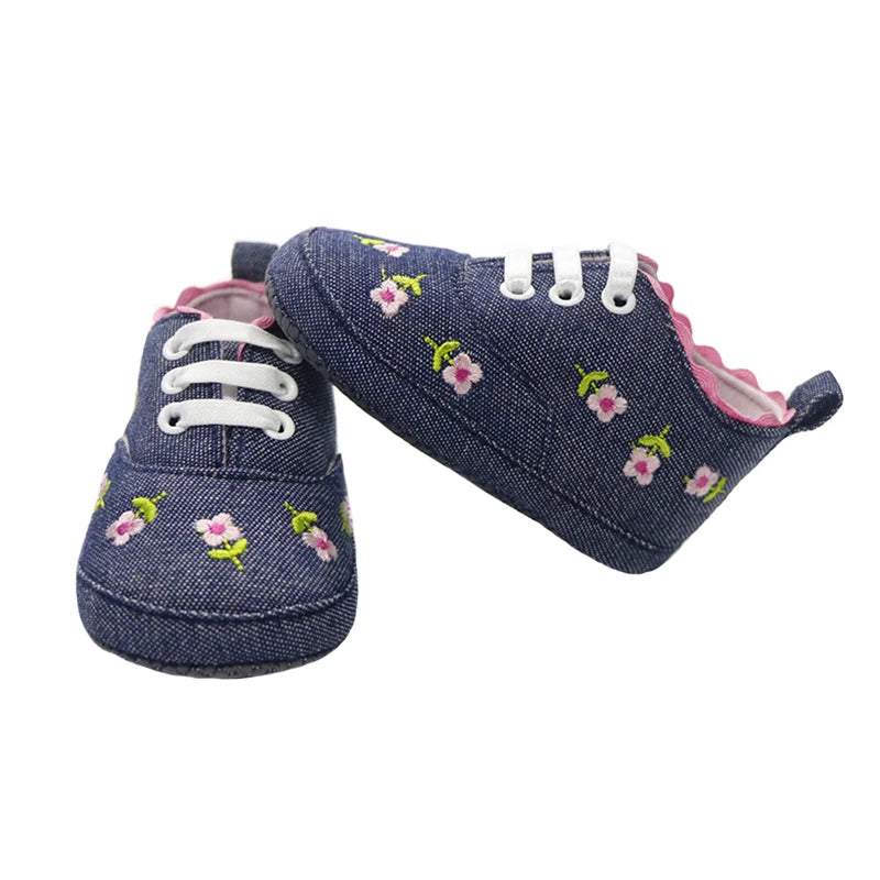 Baby girl floral embroidered first walker shoes with soft soles by Home Sweet Home, featuring delicate flower details and comfortable design.