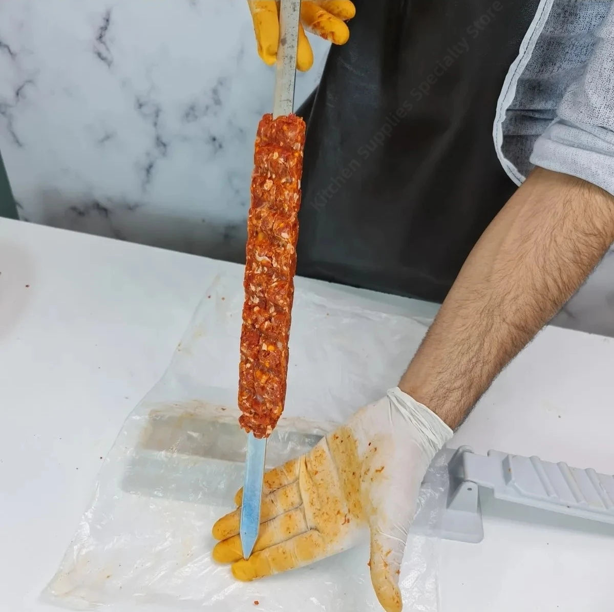 Reusable BBQ kebab skewer maker from Home Sweet Home, featuring a metal press machine for evenly shaped meat and vegetable skewers.