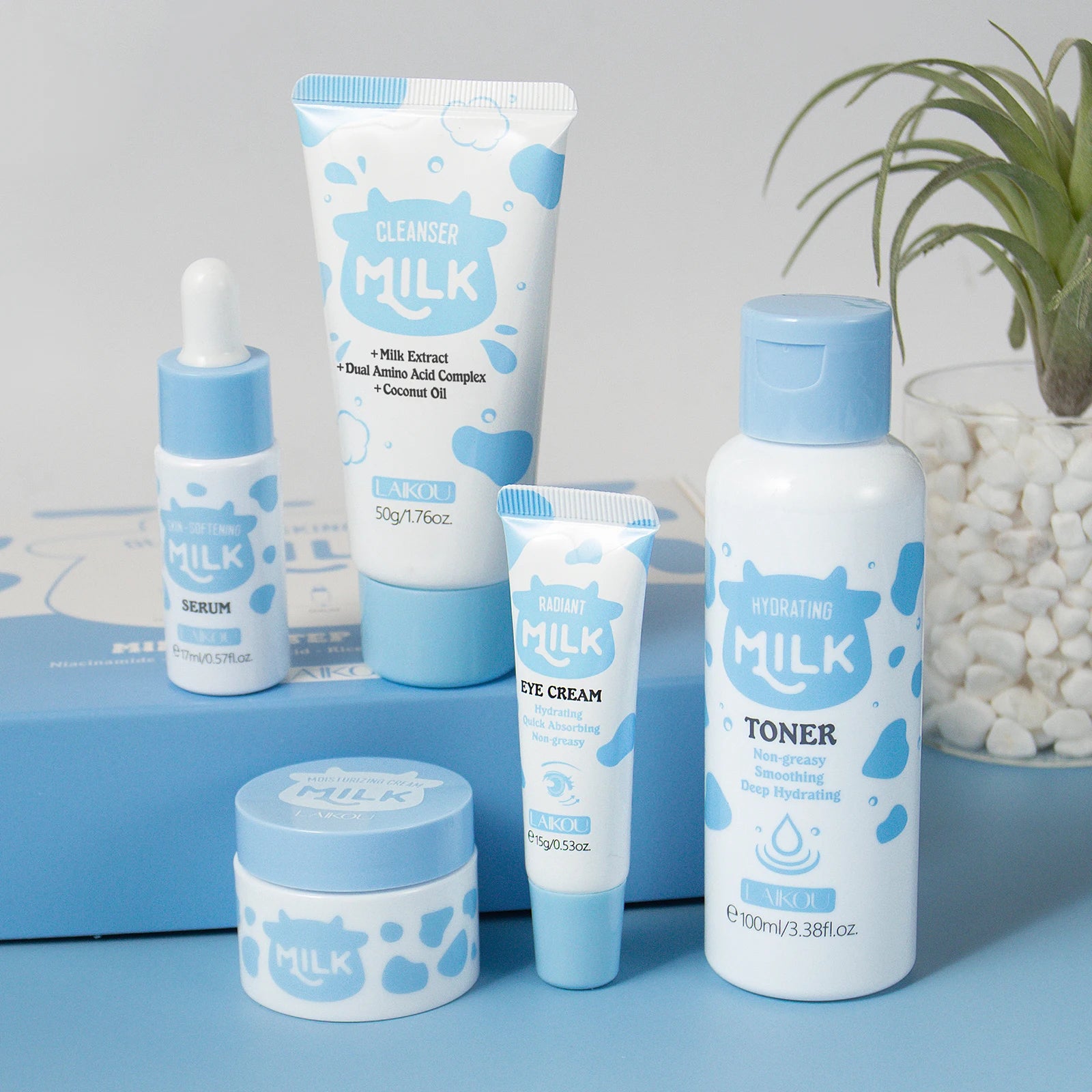 Home Sweet Home Milk Glow Skincare Set featuring bottles of moisturizer, cleanser, and serum arranged on a white background.
