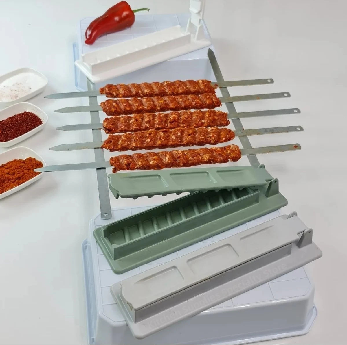 Reusable BBQ kebab skewer maker by Home Sweet Home, showing the meat press machine with skewers ready for grilling.