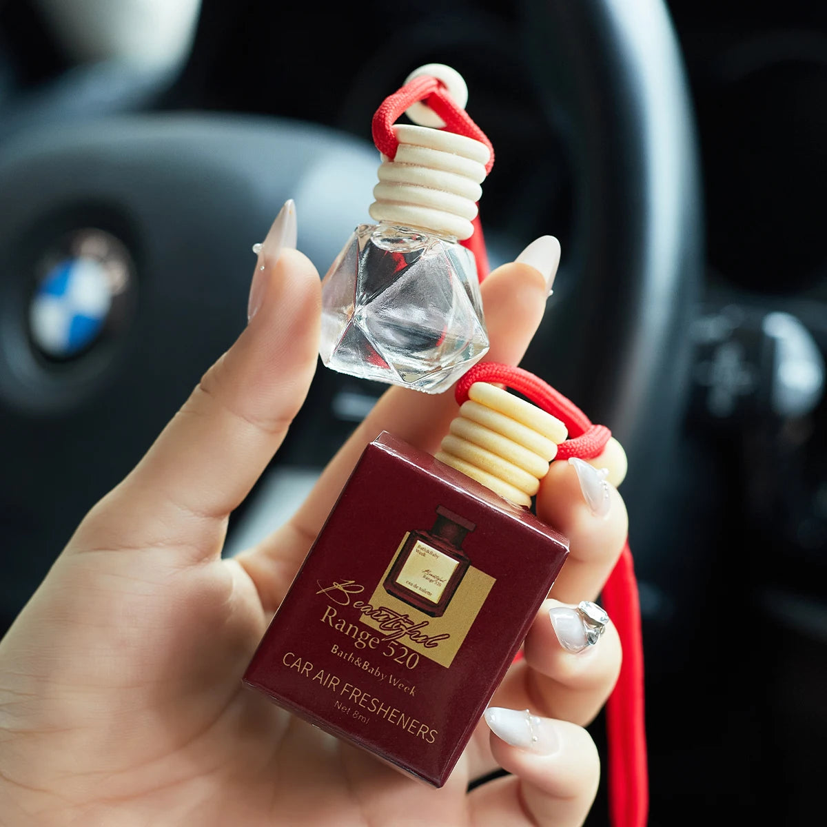 Home Sweet Home car air freshener perfume hanging in a vehicle, showcasing its sleek design and fresh scent.