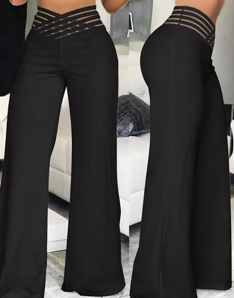 Women's high waist flare trousers from Home Sweet Home, elegant wide-leg office pants in black, styled with a tucked-in blouse.